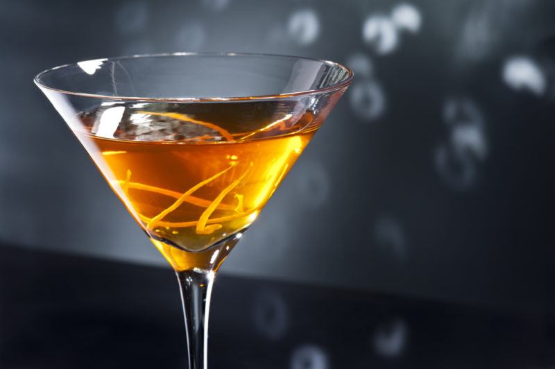 A Waldorf cocktail in a cocktail glass against a gray background