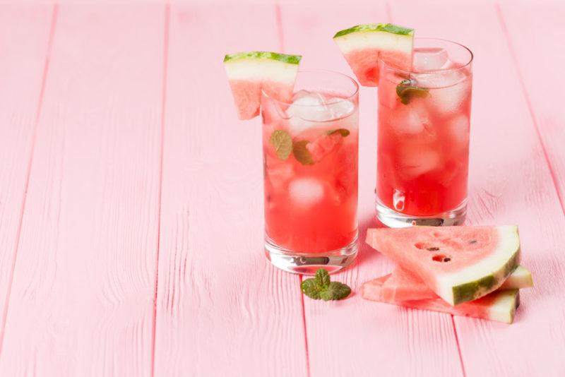 Two watermelon cocktails on a pink wooden table