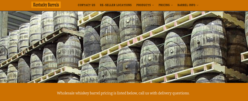 A website screenshot from Kentucky Barrels showing many barrels stacked with an orange background on the website