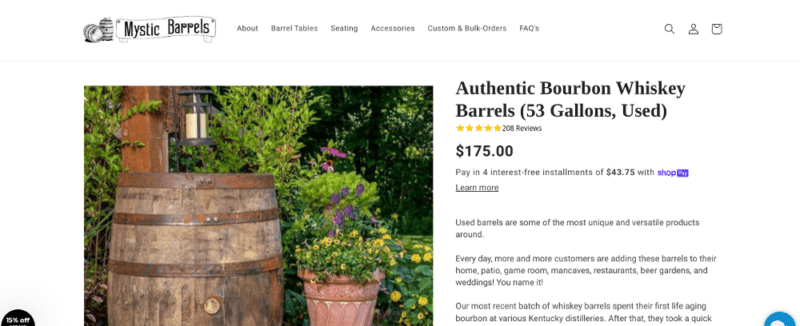 A website from Mystic Barrels showing a white background and some whiskey barrels in a garden