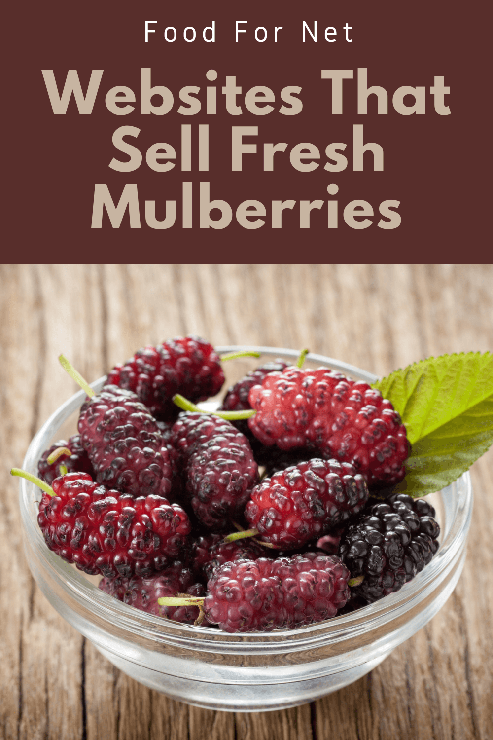 Buy Fresh Mulberries Online. A small glass bowl of fresh mulberries on a wooden table