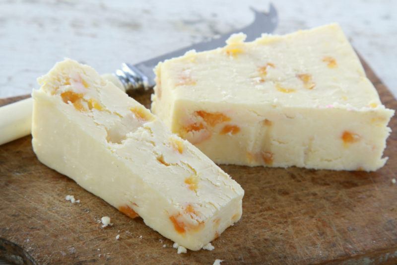 Wensleydale cheese on a board with a knife