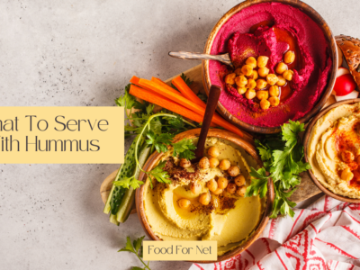 Three dishes of hummus with chickpeas on top, highlighting the question of what to serve with hummus