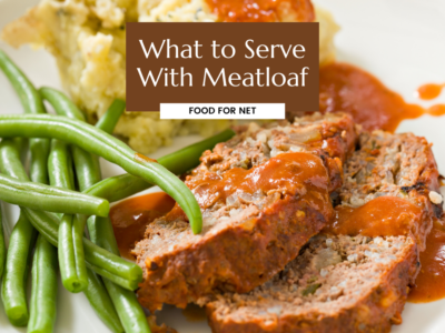 Meatloaf on plate with beans and a starchy side, looking at what to serve with meatloaf