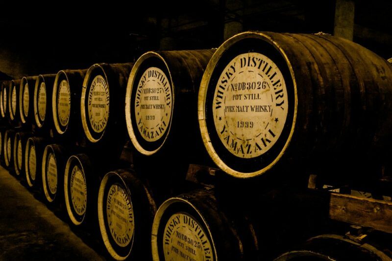 Two tiers of whiskey barrels in a cellar