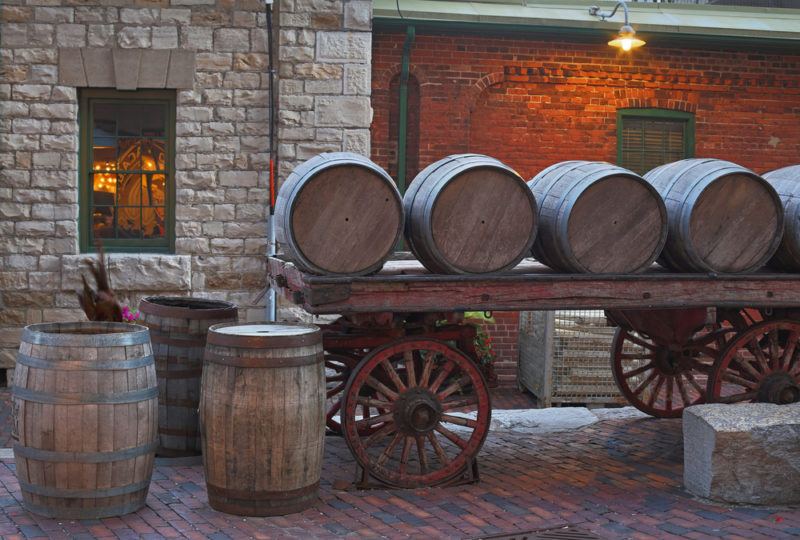 Whiskey barrels on a cart, suggesting the idea of Candian whiskey