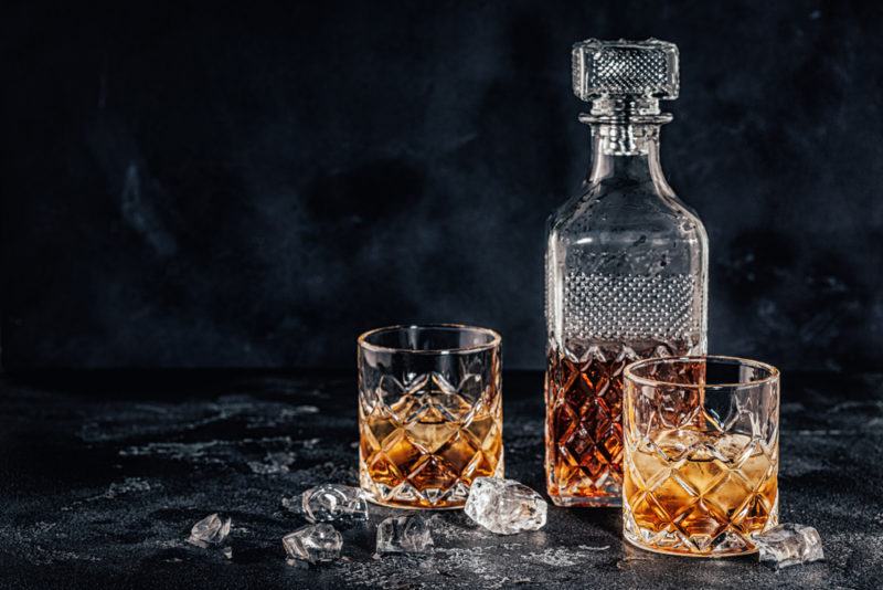 Whiskey in a Decanter with Two Glasses against a black table and background