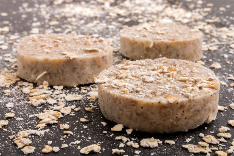 Three pieces of white pudding sliced on a board