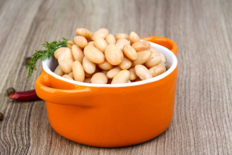 An orange container of white beans