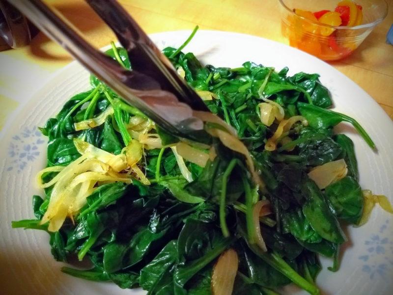 Wilted spinach cooked and served