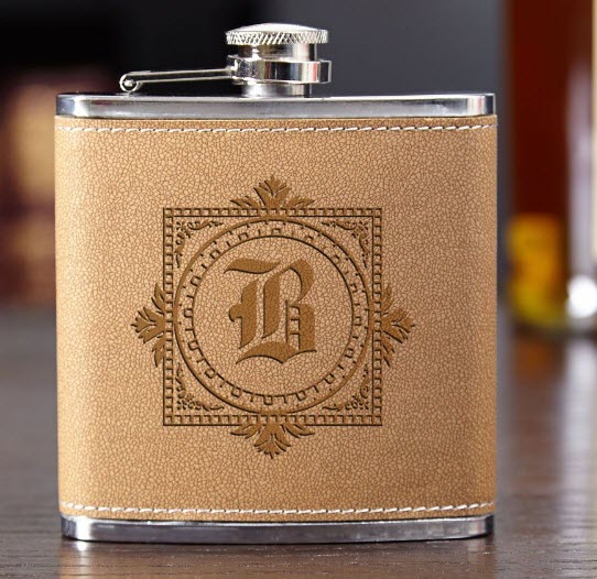 Winchester-Cocoa-Leather-Flask | Food For Net Pale brown flask with an elaborate engraving