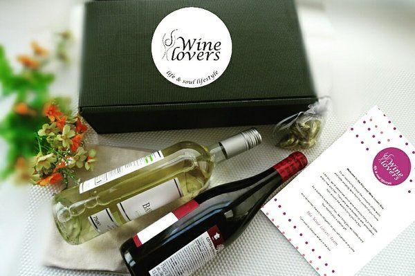 A green box with 2 bottles of wine