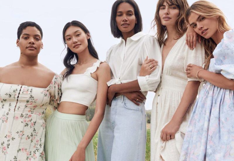 Five women standing outside wearing clothing from Nuuly