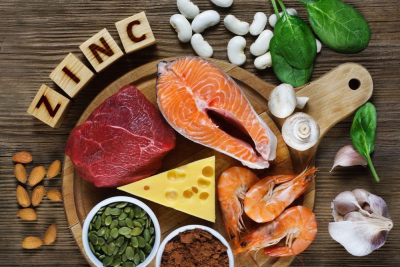 A selection of Zinc rich foods on a wooden table