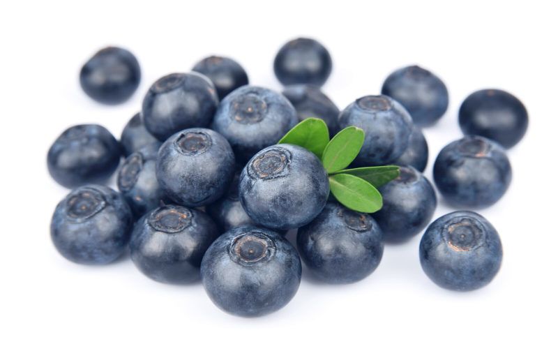 blueberries placed on top of one another on a white background