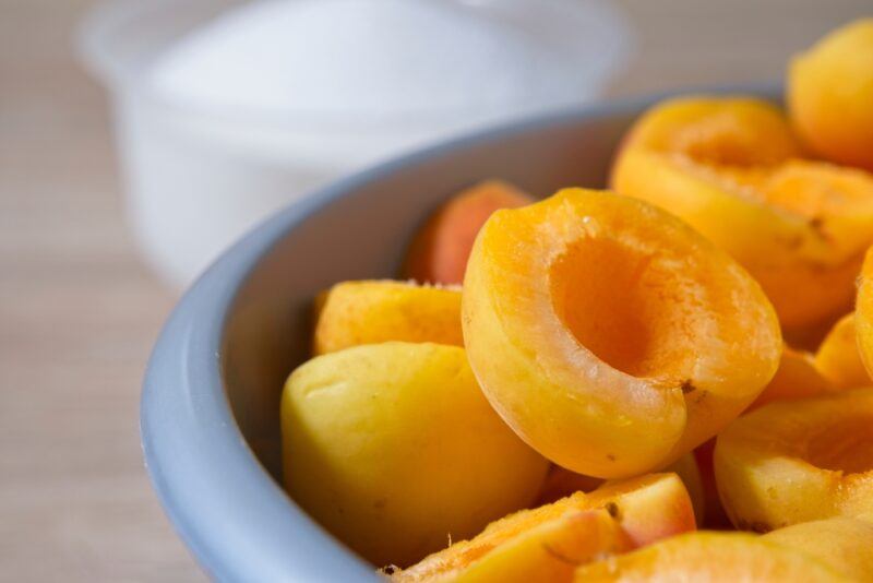 closeup image of a bluish bowl with sliced apricot