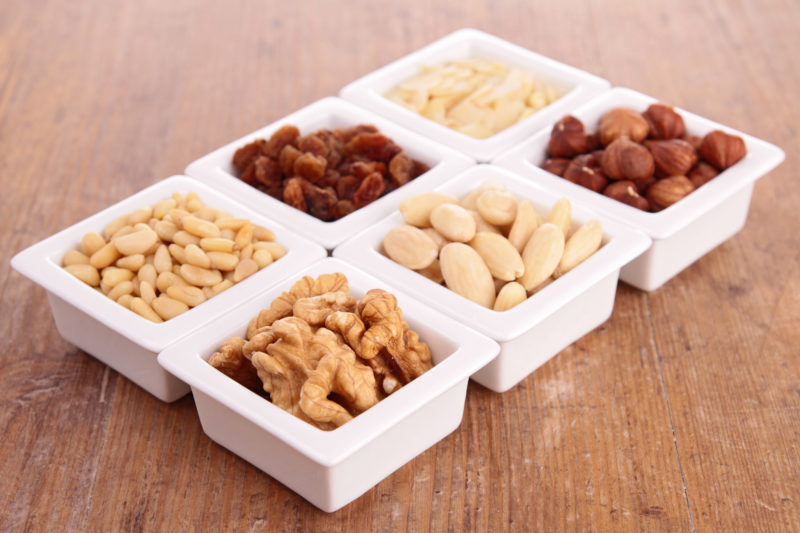 An assortment of ready to nuts in a white container. 