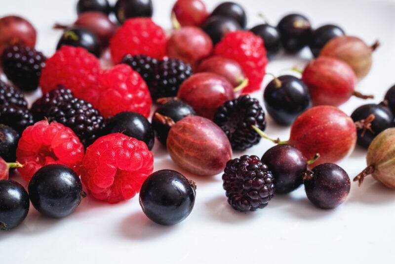 on a white surface is a spread of different berries