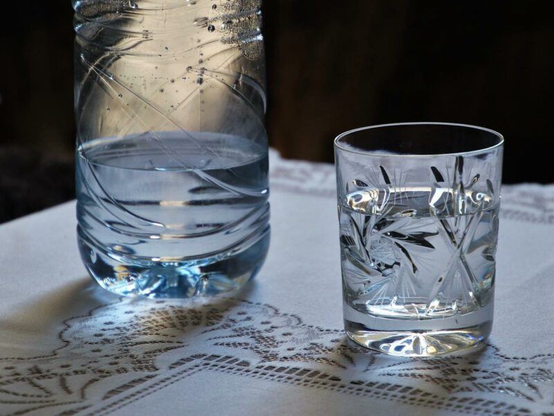 two clear glasses of water with a black background to represent the best alkaline water brands