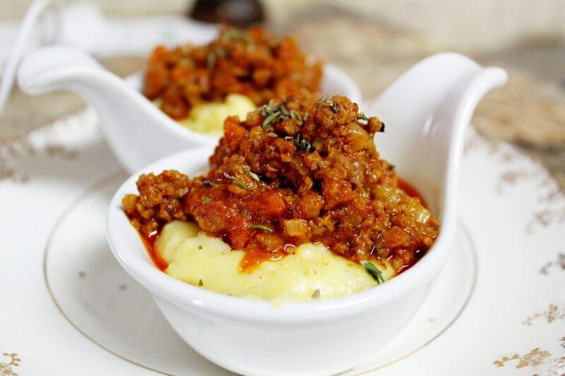 a small white dish with mashed potatoes and ground beef on top to represent the best plant-based ground beef 