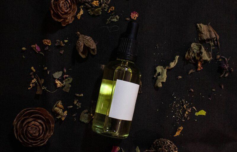 best-plant-based-shampoo | Food For Net a bottle of homemade hair product surrounded by flower petals to represent the best plant-based shampoo