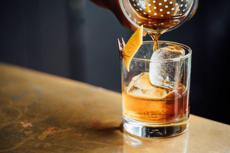 an old-fashioned in the process of being made to represent the best whiskey for old-fashioned 