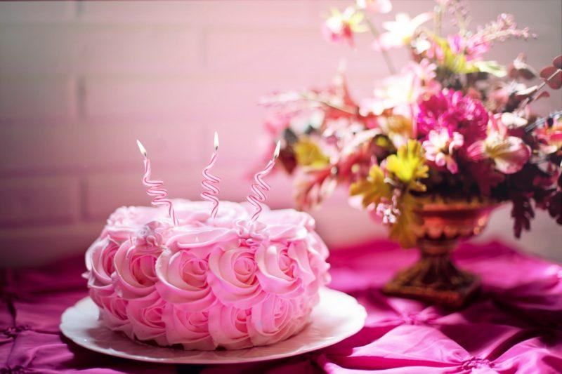 Swirly candles on a flowery cake