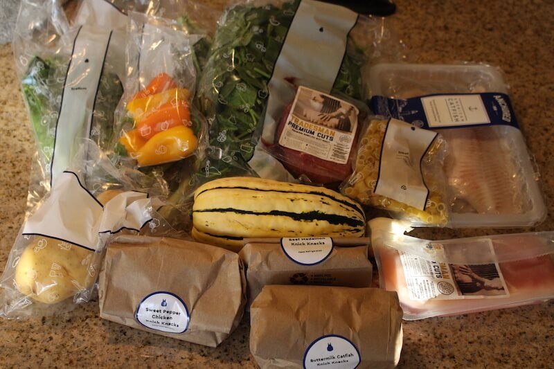 blue-apron-unboxed-with-groceries-on-counter