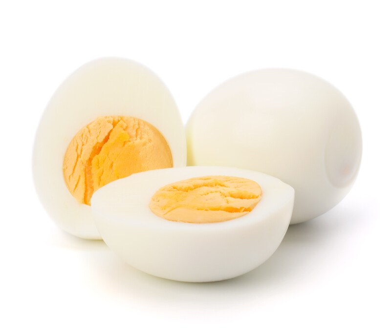 Shelled boiled eggs against a white background