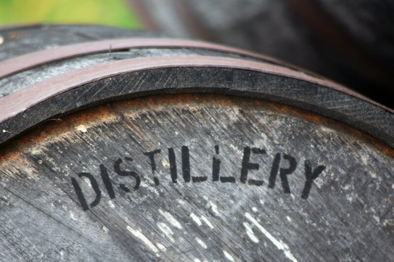 picture of an old wooden barrel with the word distiller written on it