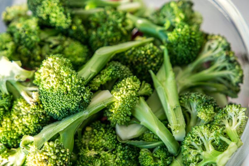 closeup image of broccoli florets in clear glass bowl