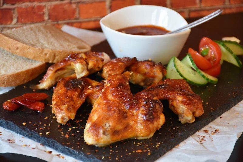 chicken wings on a platter with vegetables and dip to represent where to buy fresh chicken online 