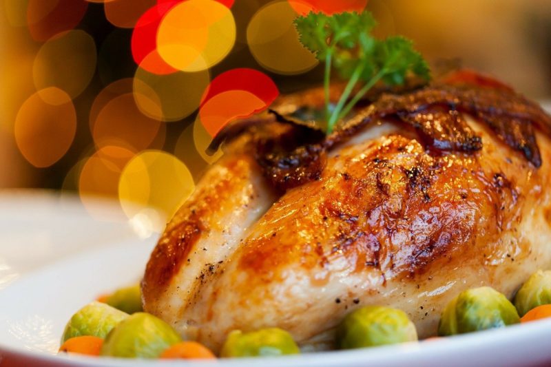 close up of a cooked turkey on a plate with a garnish on top to represent where to buy fresh turkey online 