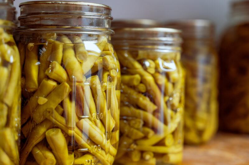 closeup image of mason jars full of canned green beans