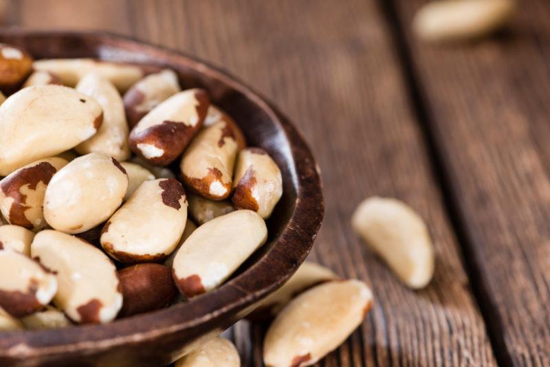 a brown bowl filled with brazil nuts | Food For Net closeup shot of peeled Brazil nuts on a brown bowl