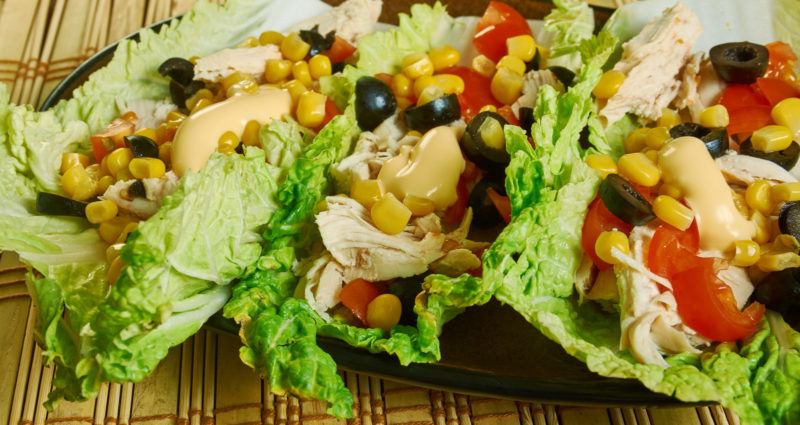 taco making use of lettuce instead of pita bread, filled with meat and vegetables