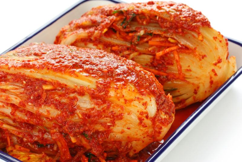 baking pan with two napa cabbages that have bene fermented | Food For Net kimchi from napa cabbage in a pan