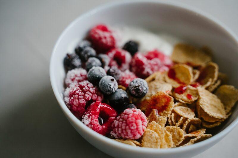 closeup image of a bowl of cereals with berries and yogurt