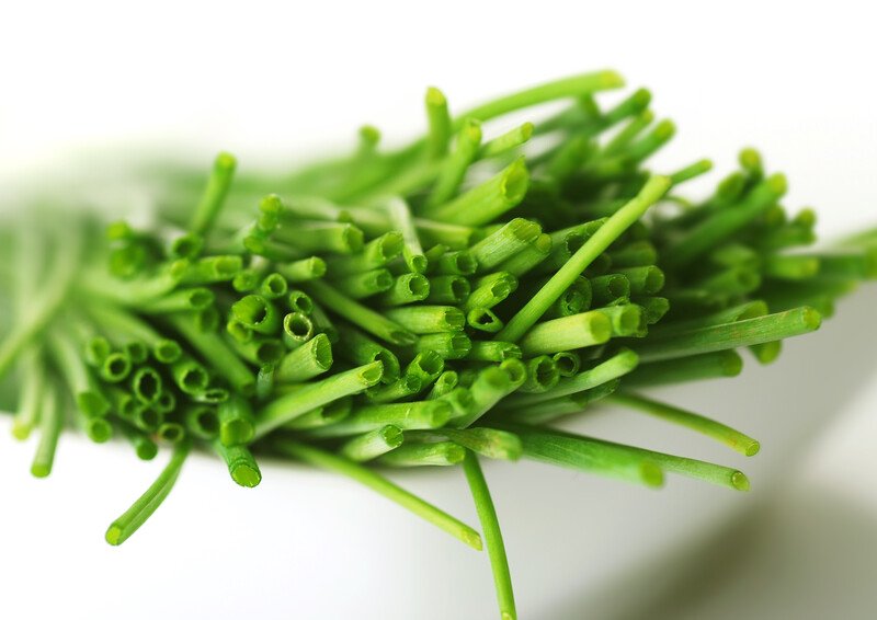 closeup image of fresh chives in a white bowl