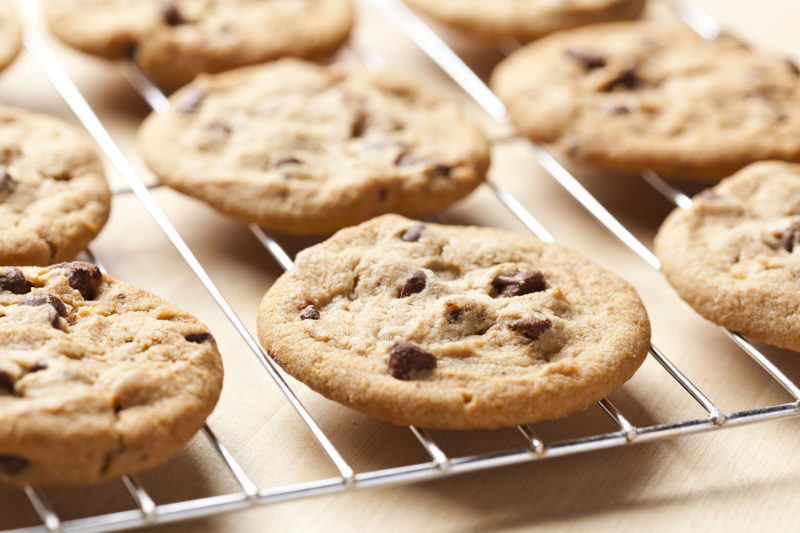 Fresh chocolate chip cookies on a cooling rack. 