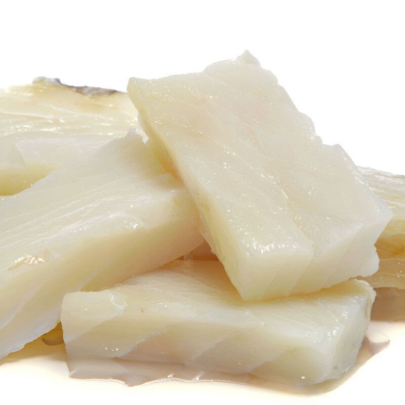 Four pieces of raw cod rest against a white background.