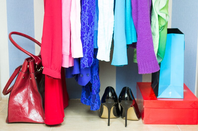 Clothes Subscription Boxes - colorful clothes in a wardrobe with shoes, handbag, and a box and store bag on the right