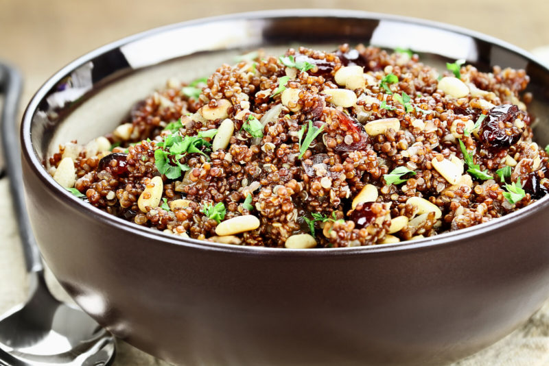 cooked quinoa served with nuts and basil