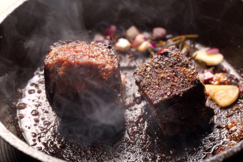 cooking steak tips on cast iron skillet