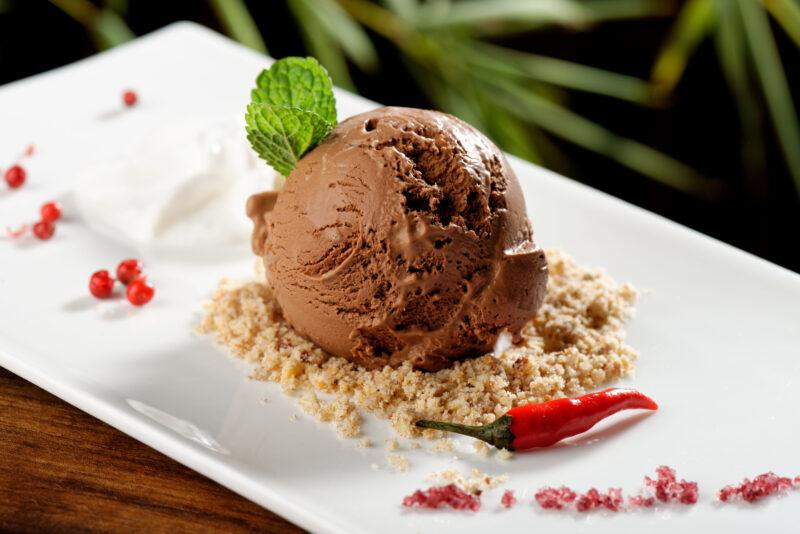 Desserts That Go With Chili. chocolate ice cream with chili pepper on serving dish