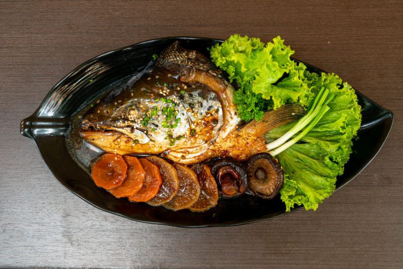 whole fish head cooked with mushrooms, carrots, and served with lettuce