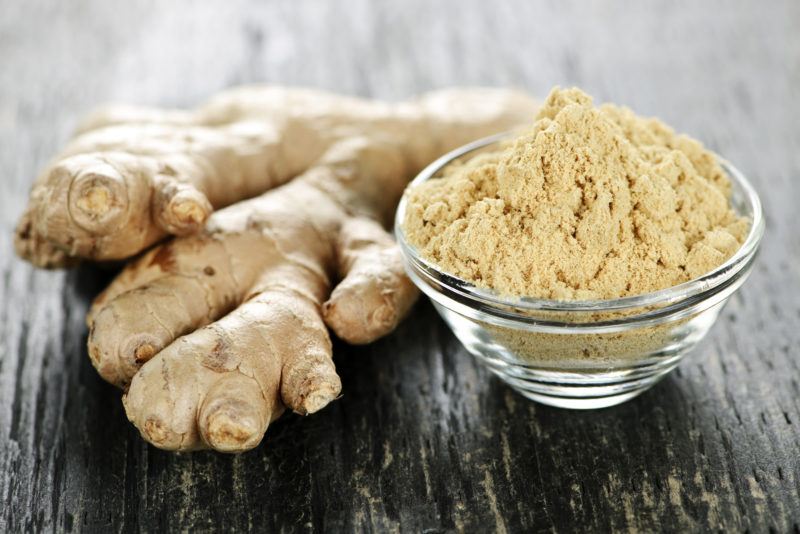 fresh ginger and freshly-grated ginger on a glass bowl