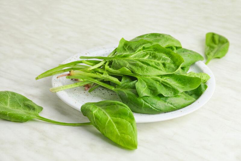 Plate,With,Fresh,Green,Spinach,On,Table | Food For Net on marble surface is a white plate with fresh spinach