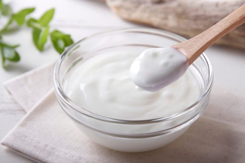Fresh,Yogurt,On,The,Table | Food For Net A white dish filled with yogurt, with some being taken out on a wooden spoon