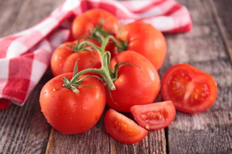 fresh red tomatoes on a wooden table